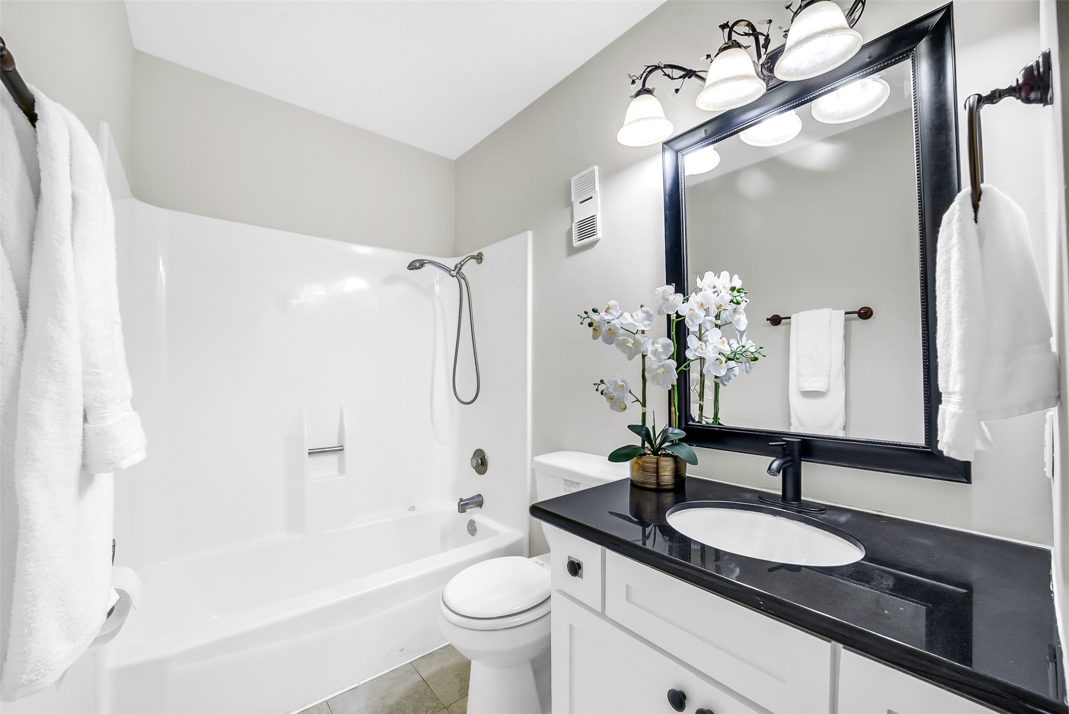 6531 Wanda Lane Houston, TX 77074 - Photo 17 of 29 a bathroom with a granite countertop sink a toilet and shower