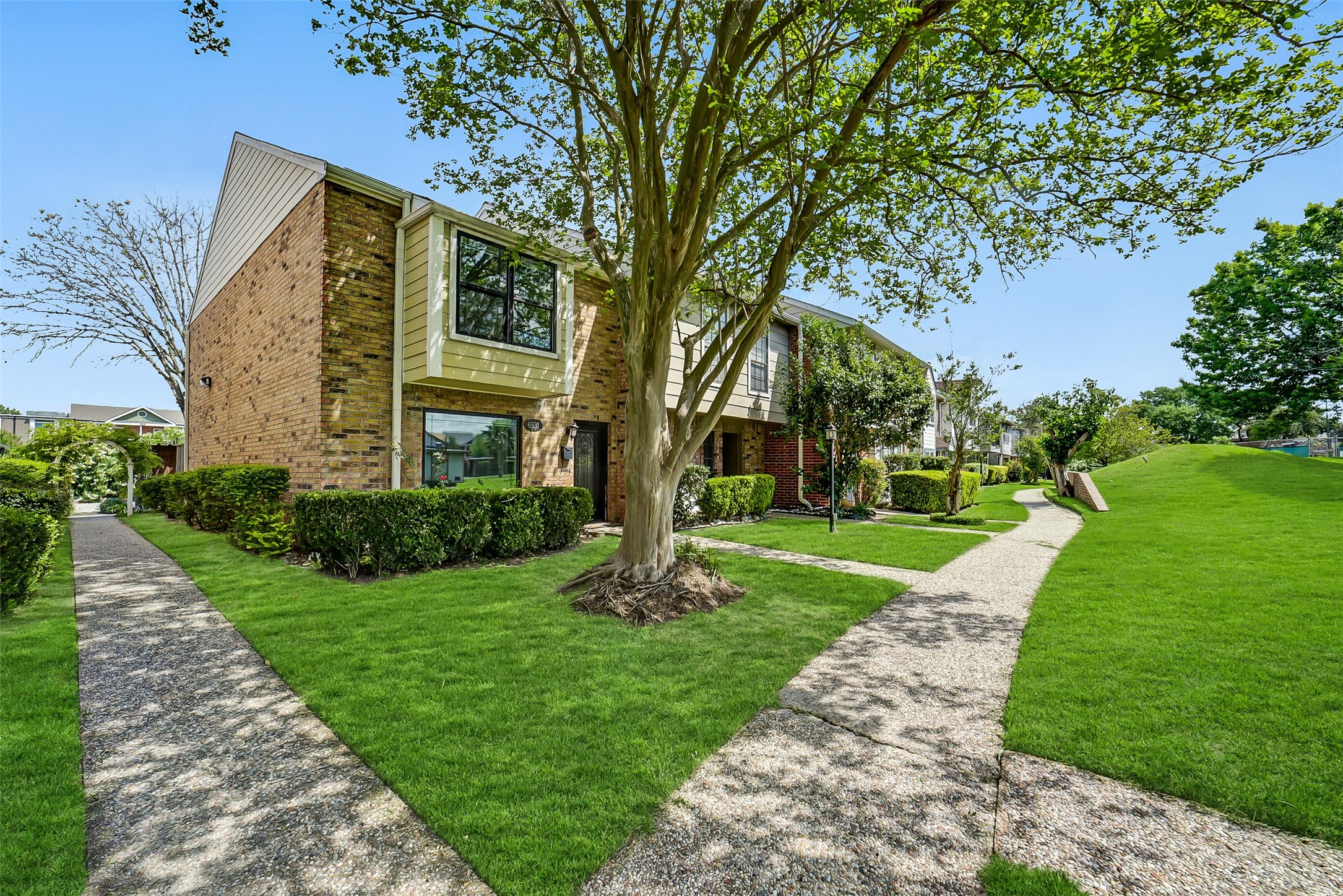 6531 Wanda Lane Houston, TX 77074 - Photo 2 of 29 a view of a fountain in front of a big yard with large trees