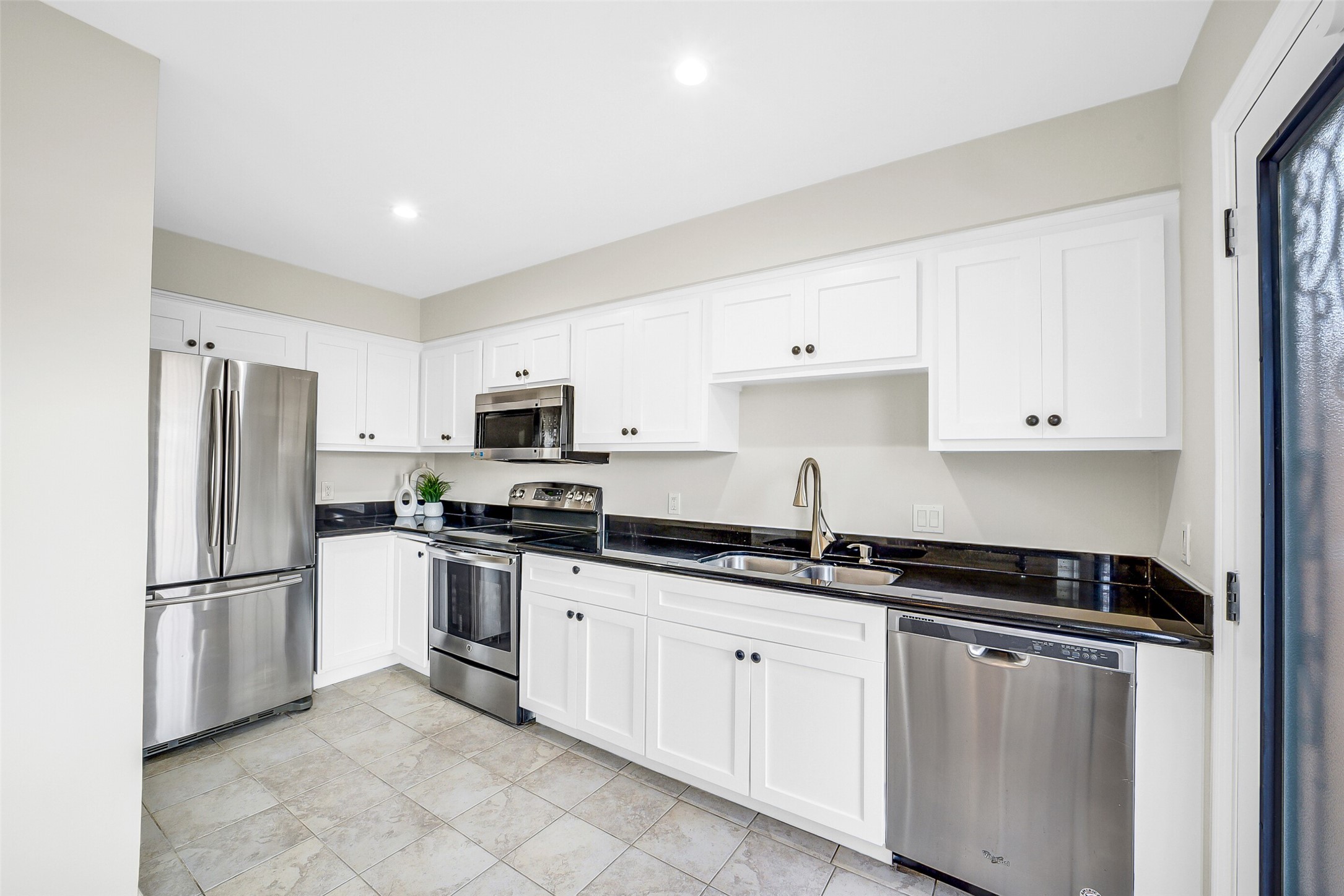 6531 Wanda Lane Houston, TX 77074 - Photo 9 of 29 a kitchen with granite countertop a refrigerator and a sink