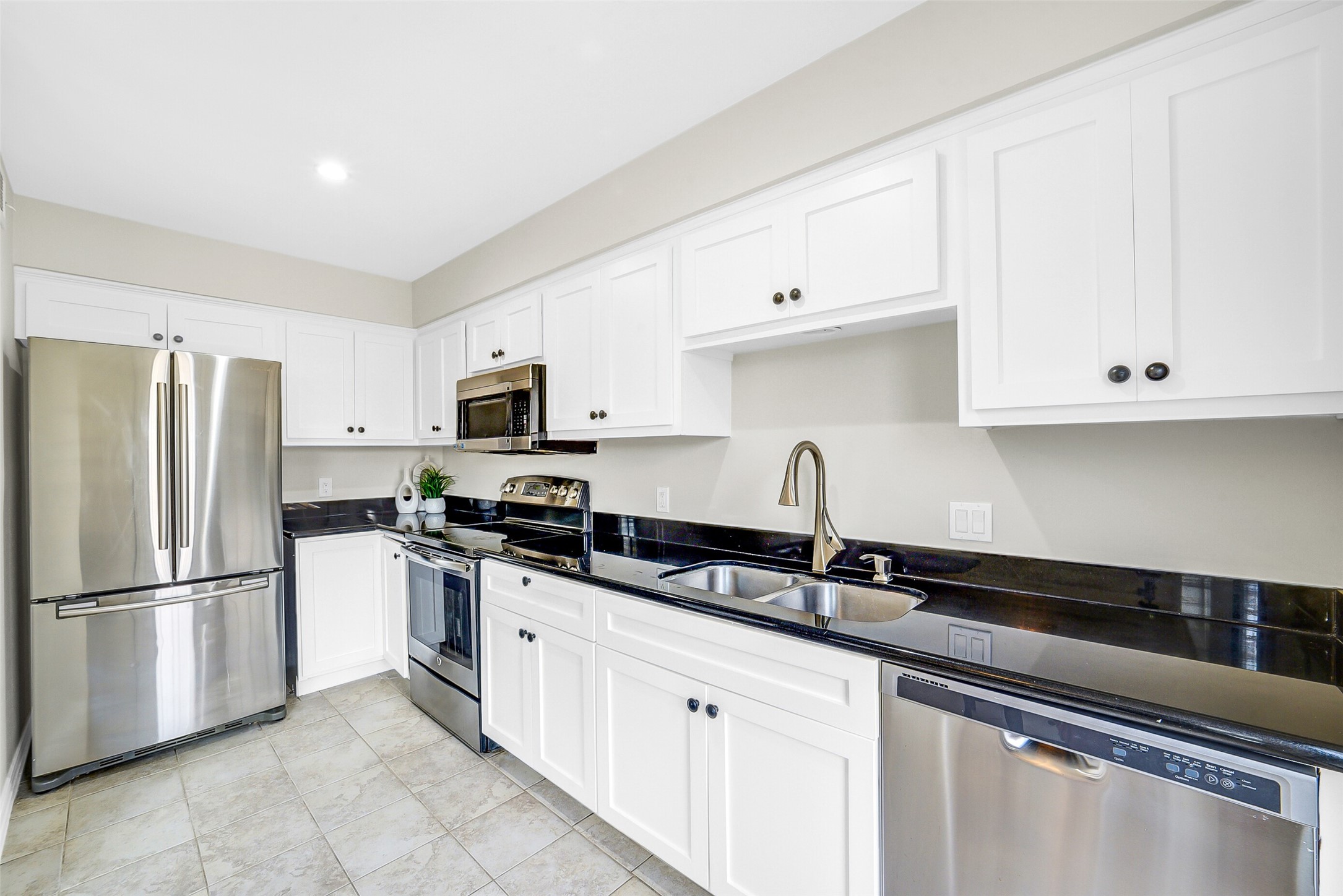 6531 Wanda Lane Houston, TX 77074 - Photo 10 of 29 a kitchen with granite countertop white cabinets white stainless steel appliances and a sink