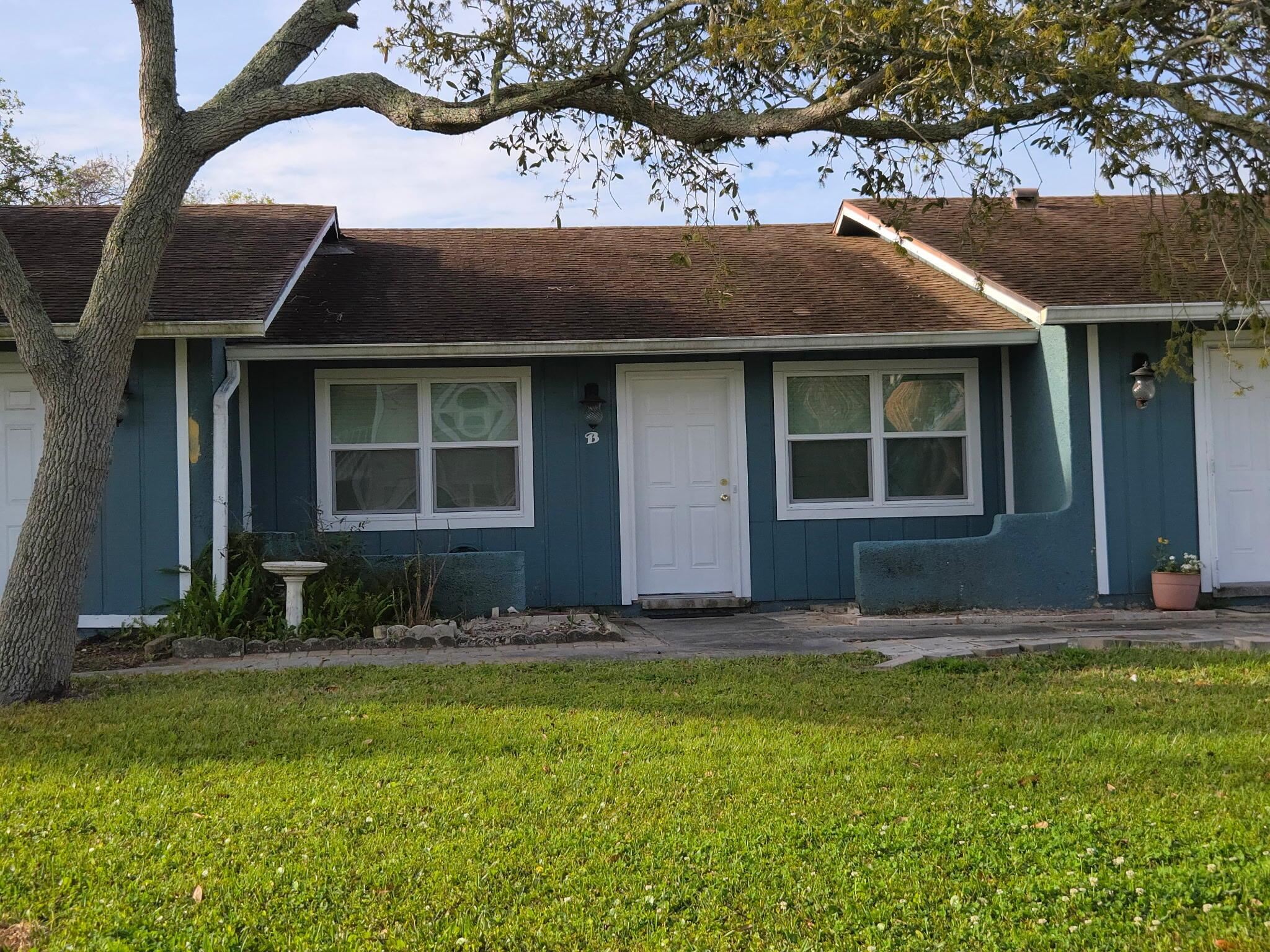 125 Rio Del Mar Street, Unit B St. Augustine, FL 32080 - Photo 3 of 17 Ranch-style home with a front yard, roof with shingles, and board and batten siding