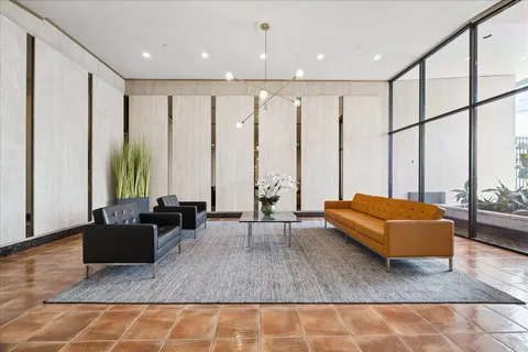 a living room with furniture rug and wooden floor