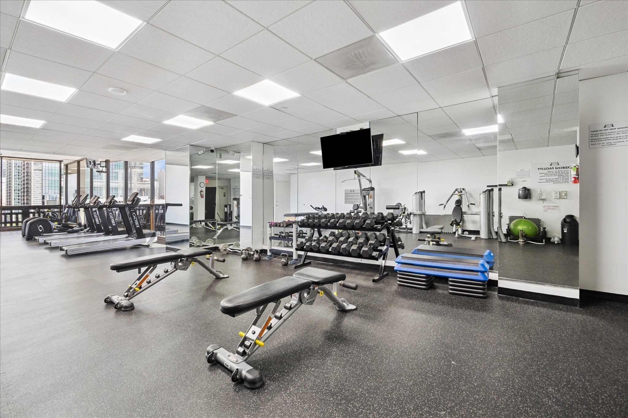 2016 Main Street, Unit 2417 Houston, TX 77002 - Photo 18 of 40 a room with gym equipment and mirrors