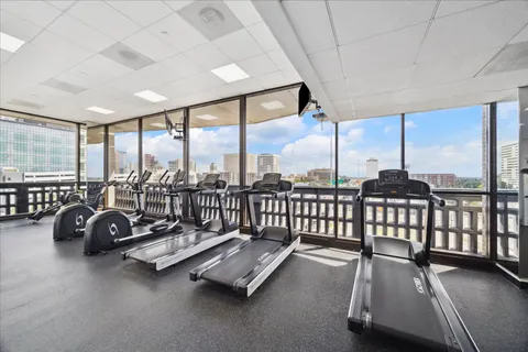 a view of a room with gym equipment and floor to ceiling window