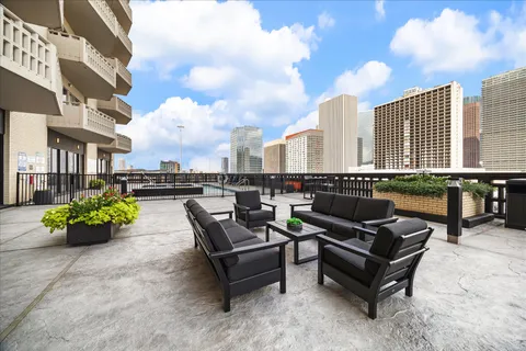 a terrace with outdoor seating and city view