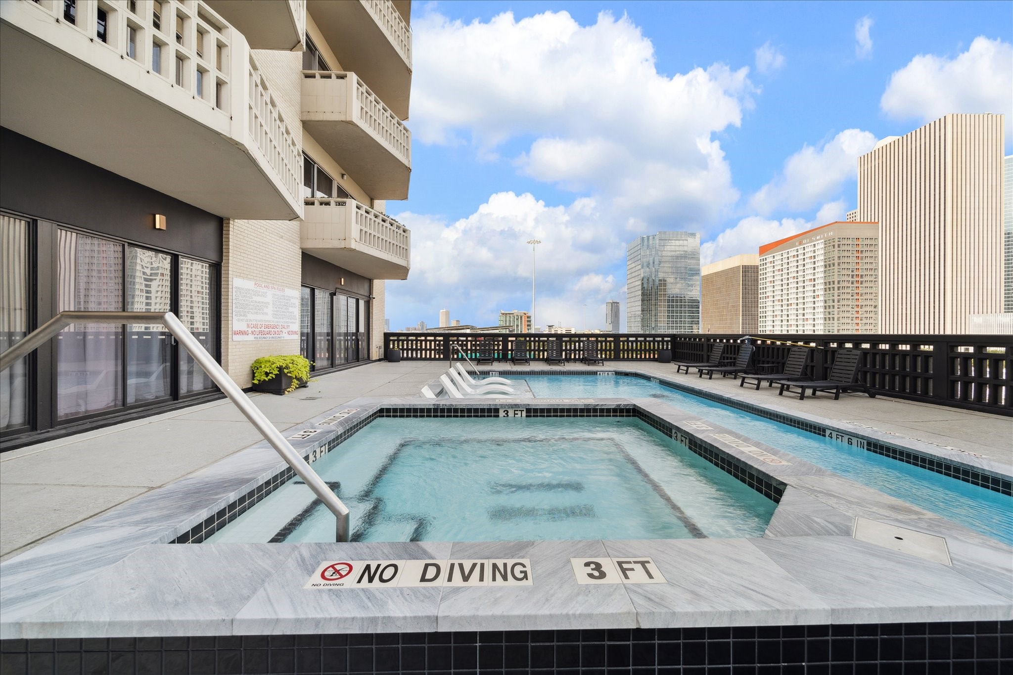 2016 Main Street, Unit 2417 Houston, TX 77002 - Photo 35 of 40 a view of a swimming pool with a chair