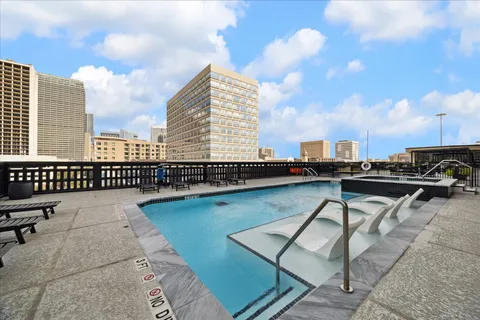 a view of swimming pool with outdoor seating and barbeque oven