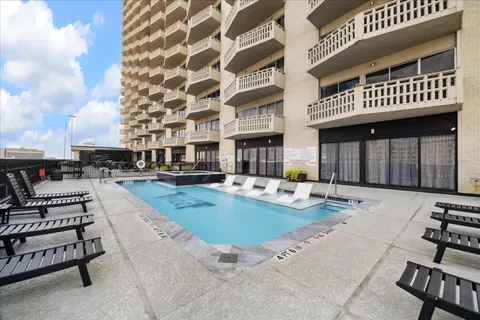 a view of a house with swimming pool and sitting area