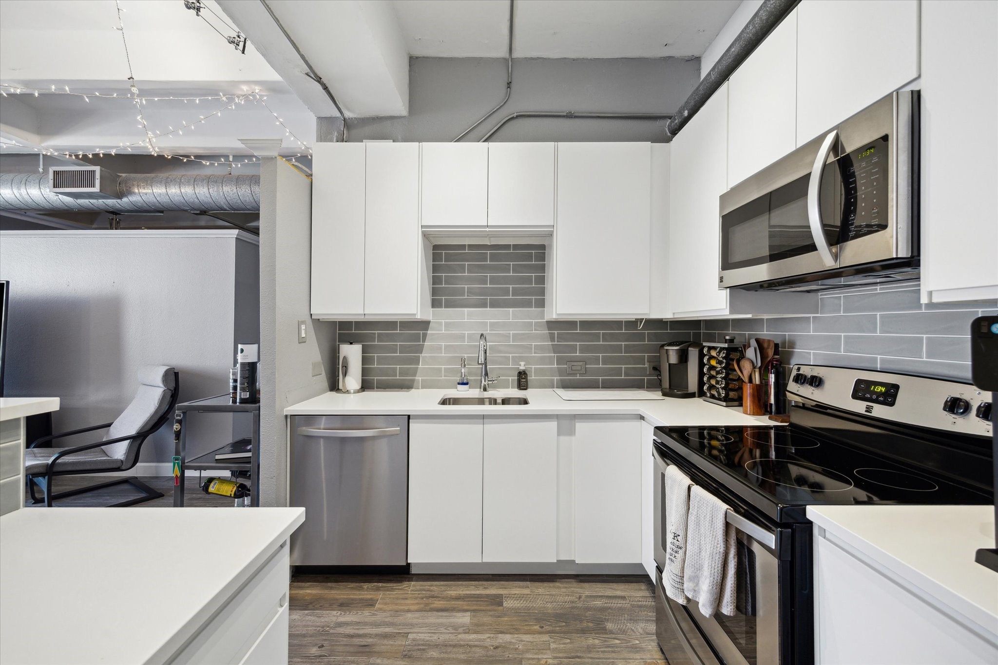 2016 Main Street, Unit 2417 Houston, TX 77002 - Photo 6 of 40 a kitchen with stainless steel appliances a sink stove and cabinets