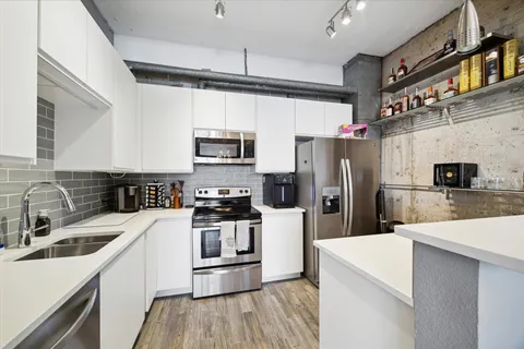 a kitchen with a sink a stove a microwave and refrigerator