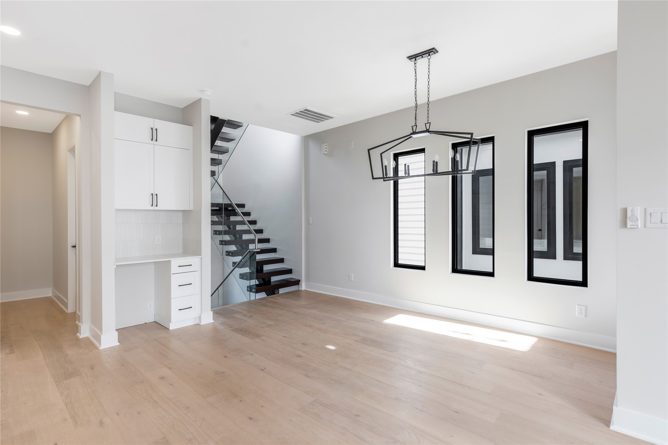 2239 Blalock Road Houston, TX 77080 - Photo 13 of 33 a view of an empty room with window and stairs