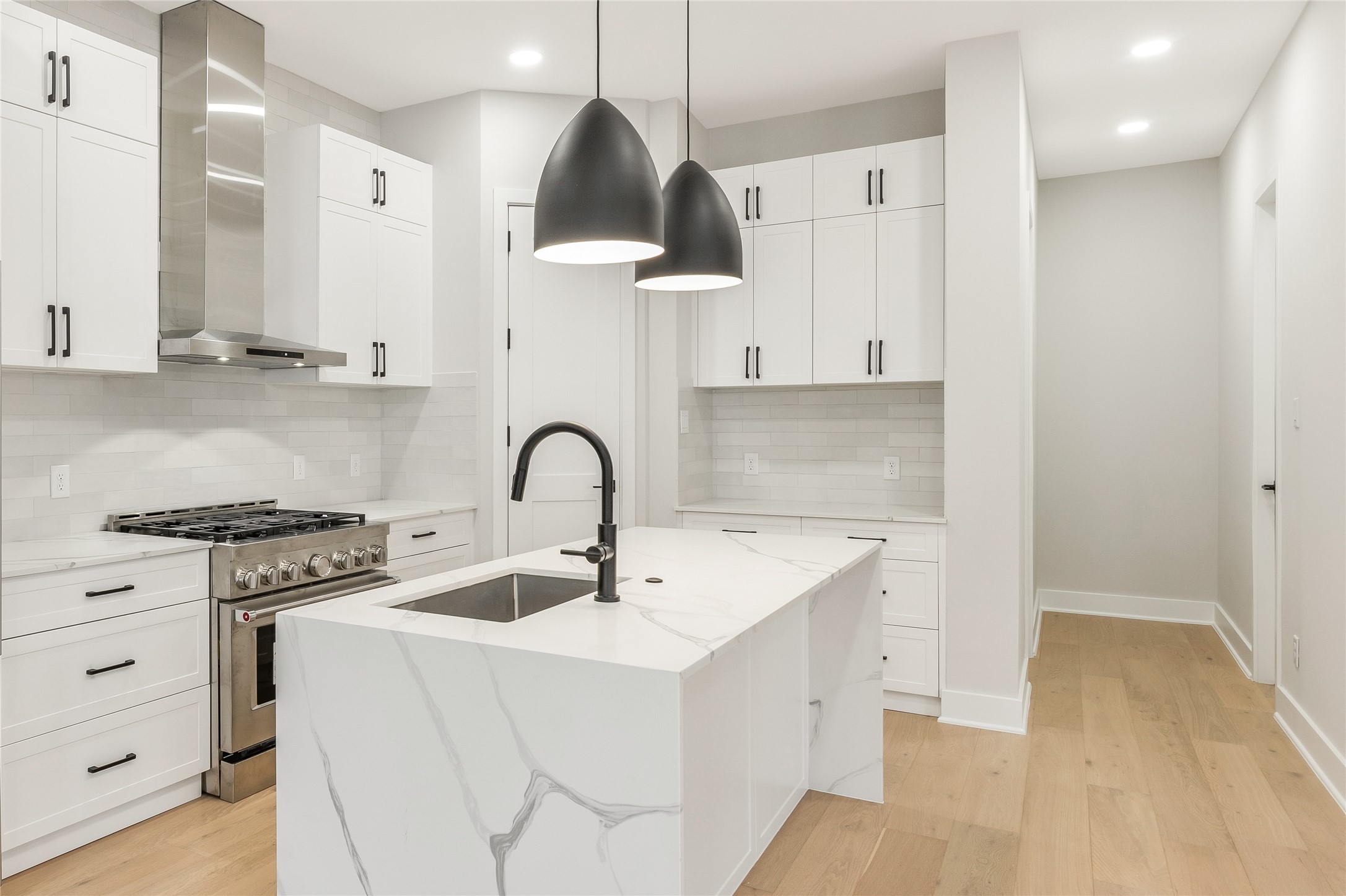 2239 Blalock Road Houston, TX 77080 - Photo 10 of 33 a kitchen with stainless steel appliances a stove a sink and white cabinets