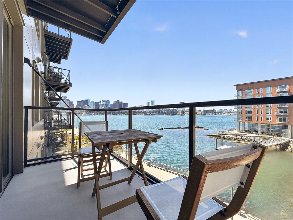 a view of a chairs and table in the balcony