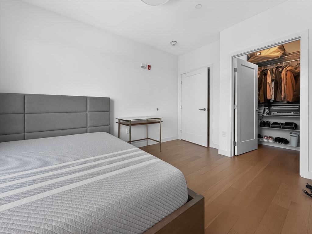 45 Lewis Street, Unit 316 Boston, MA 02128 - Photo 11 of 32 a bedroom with a bed and a view of bathroom
