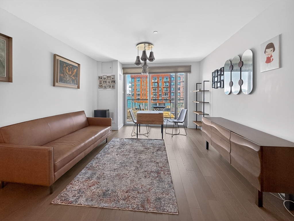 45 Lewis Street, Unit 316 Boston, MA 02128 - Photo 6 of 32 a living room with furniture and a wooden floor