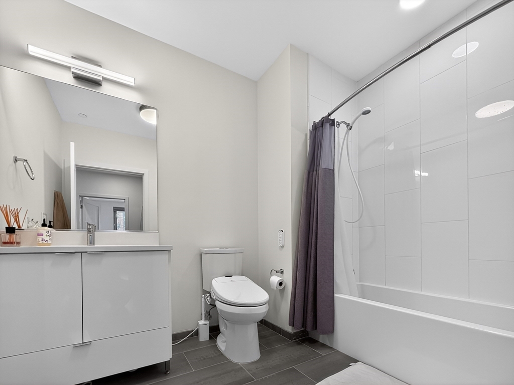 45 Lewis Street, Unit 316 Boston, MA 02128 - Photo 7 of 32 a bathroom with a toilet sink and shower