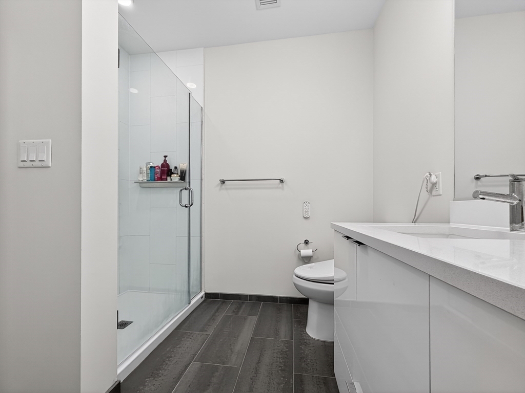 45 Lewis Street, Unit 316 Boston, MA 02128 - Photo 9 of 32 a bathroom with a sink and toilet