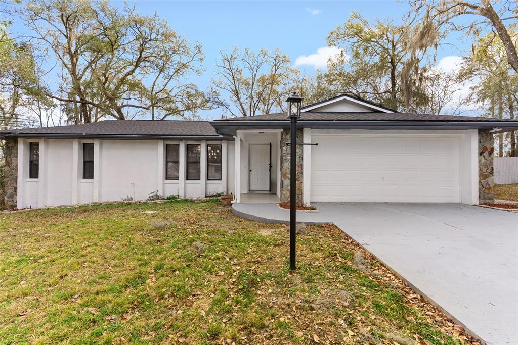 6096 East Tremont Street Inverness, FL 34452 - Photo 1 of 47 a front view of house with yard
