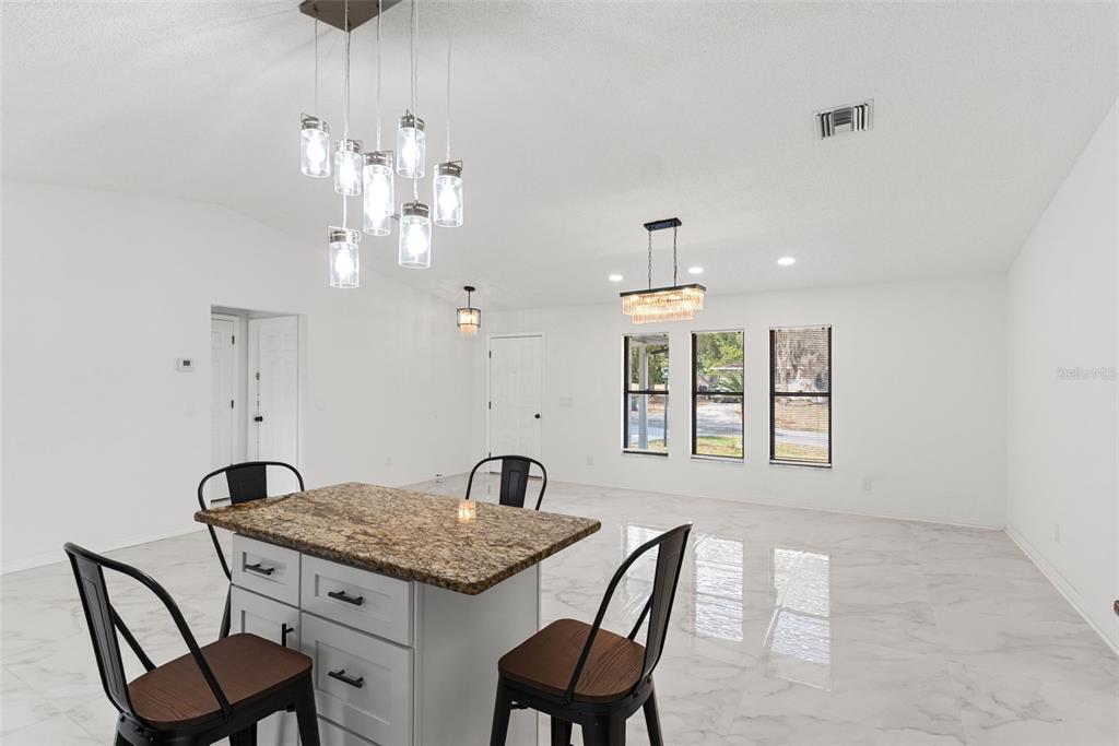 6096 East Tremont Street Inverness, FL 34452 - Photo 19 of 47 a view of a dining room with furniture window and outside view