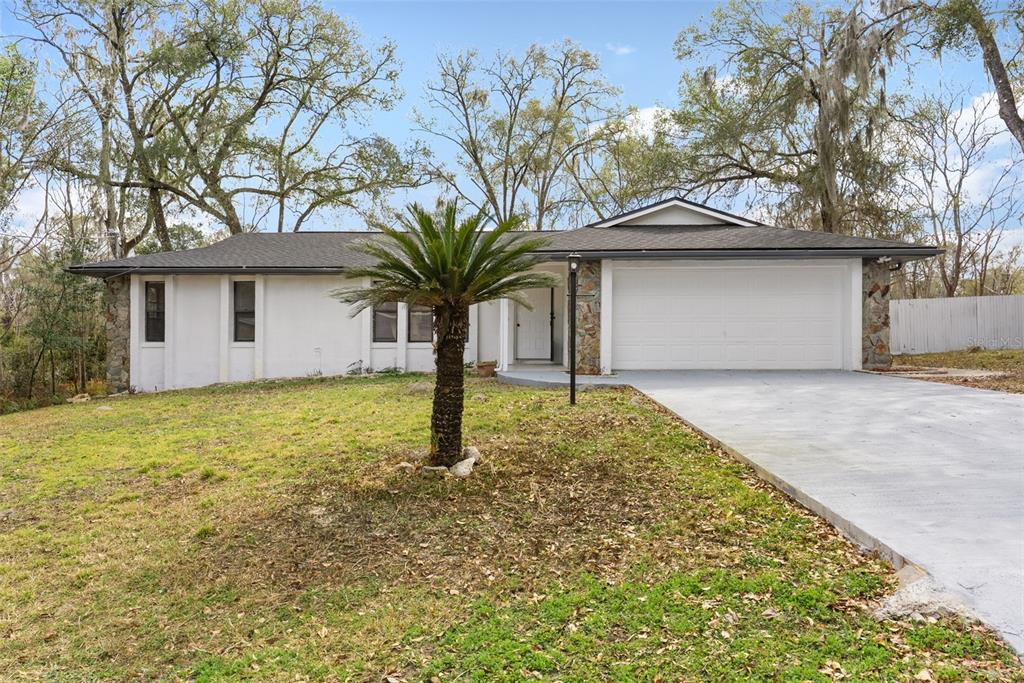 6096 East Tremont Street Inverness, FL 34452 - Photo 2 of 47 a front view of house with small garden