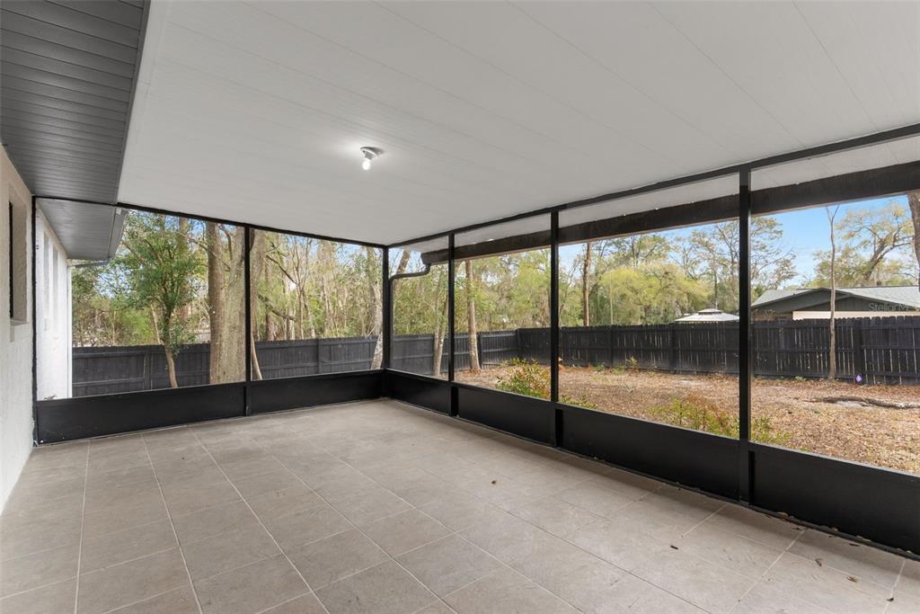 6096 East Tremont Street Inverness, FL 34452 - Photo 32 of 47 a view of an empty room with wooden floor and a large window