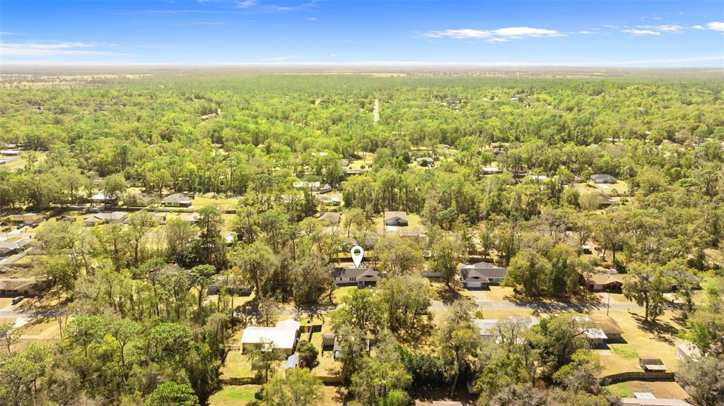 6096 East Tremont Street Inverness, FL 34452 - Photo 39 of 47 an aerial view of residential houses with outdoor space and trees