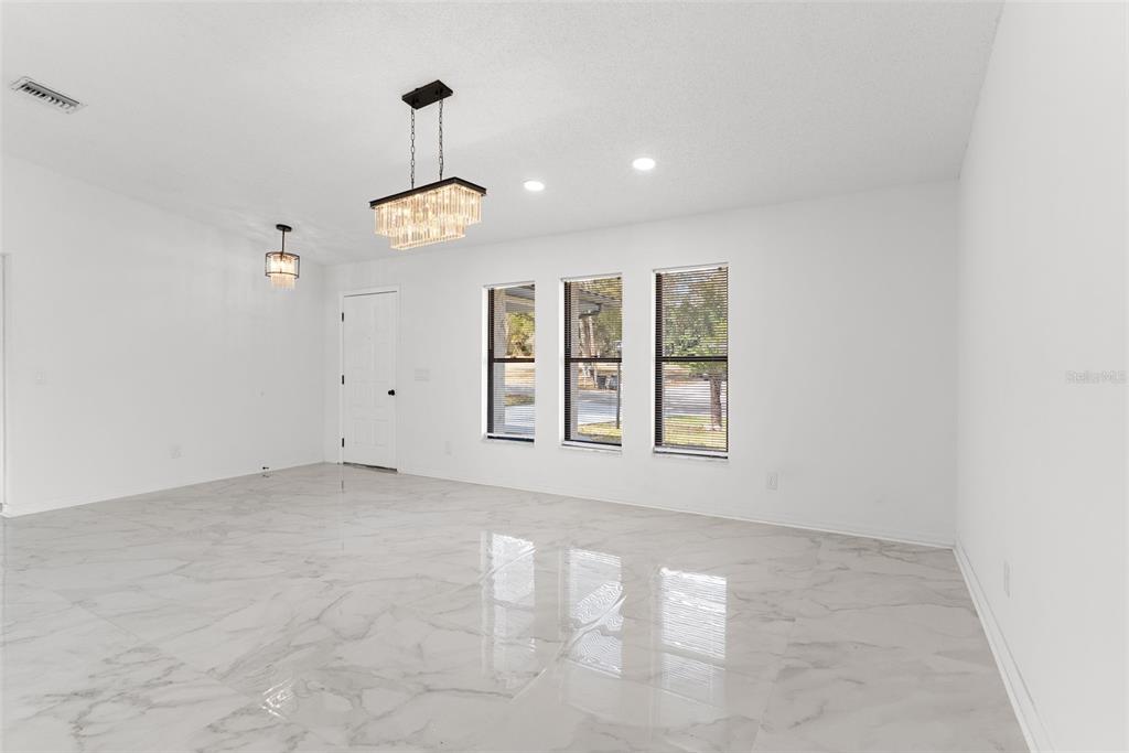 6096 East Tremont Street Inverness, FL 34452 - Photo 9 of 47 an empty room with windows and ceiling fan