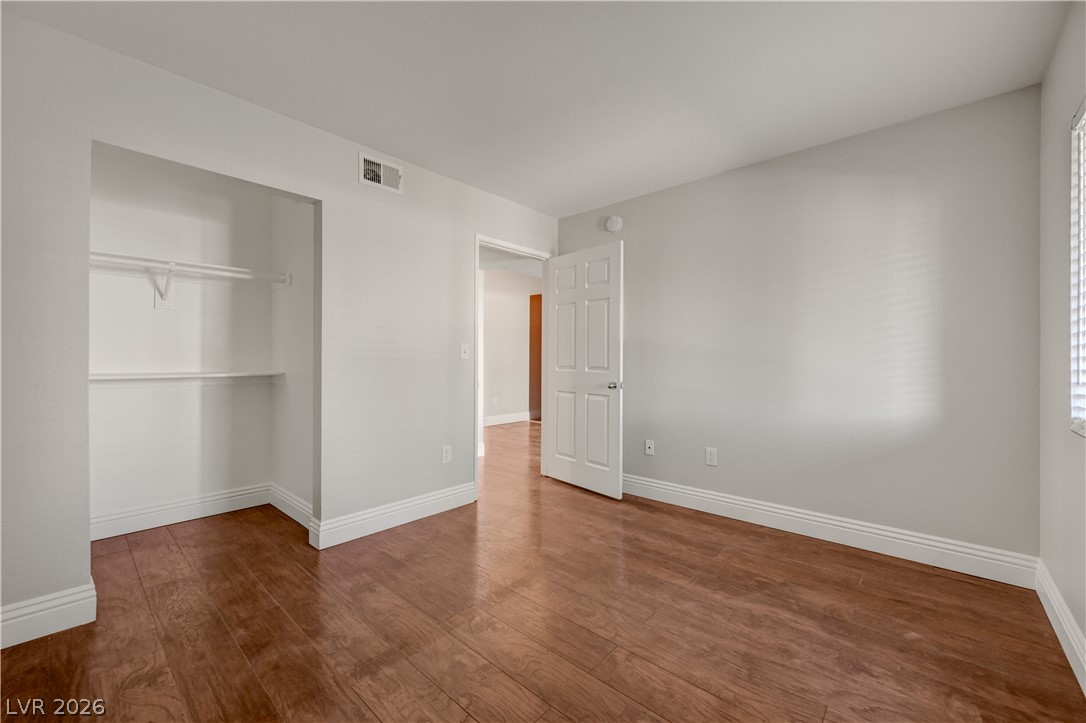 7885 West Flamingo Road, Unit 1050 Las Vegas, NV 89147 - Photo 28 of 62 Rich hardwood flooring complements the simple, clean lines of this accommodating bedroom.
