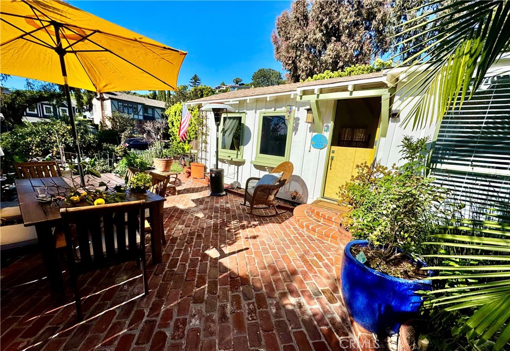 a view of a patio with table and chairs and potted plants