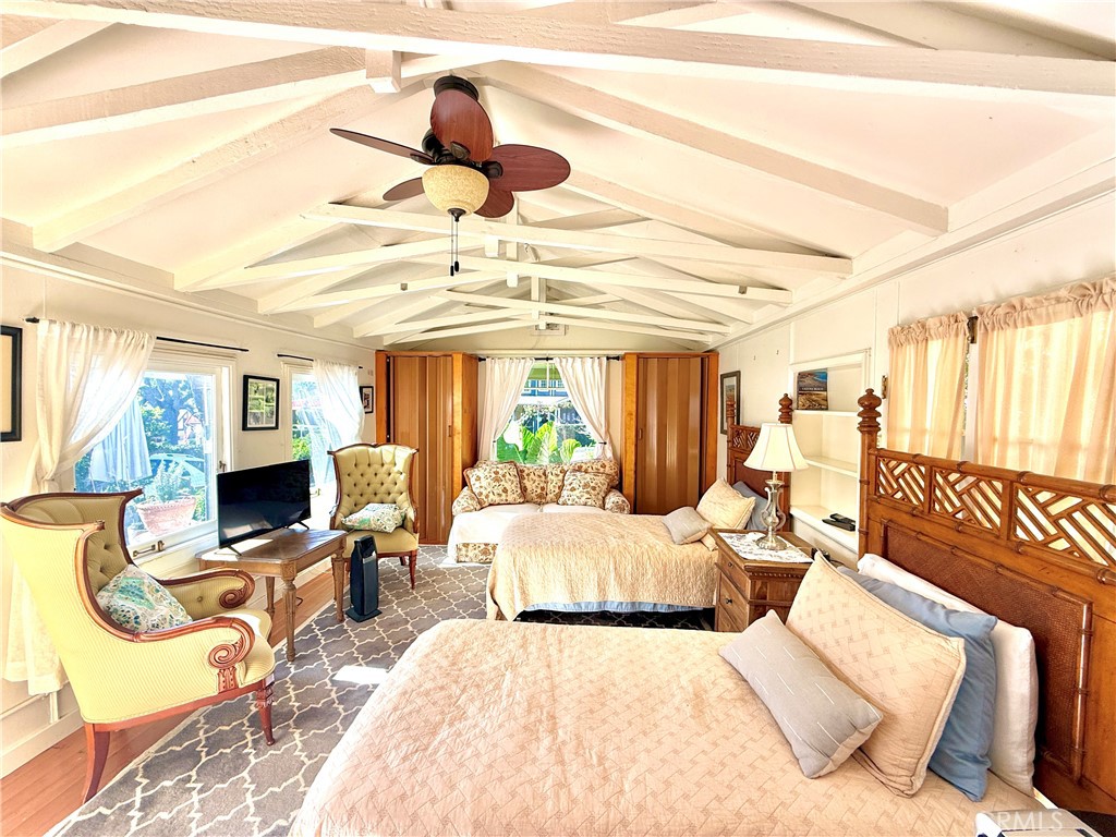 455 Myrtle Street Laguna Beach, CA 92651 - Photo 9 of 9 a bedroom with a bed couch and flat screen tv