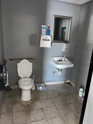 a bathroom with a toilet a sink and a mirror