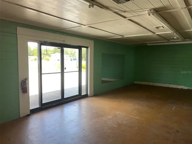 a view of a livingroom with an empty space and a window