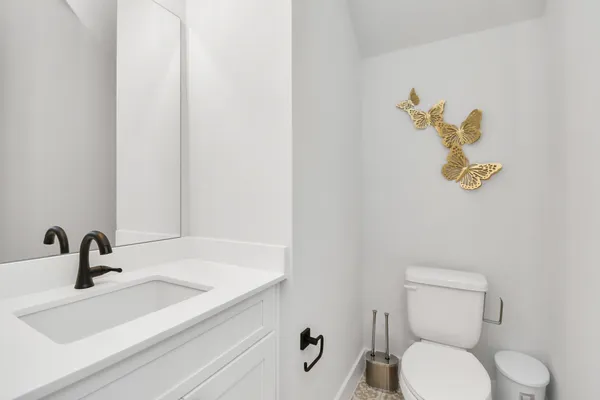 a bathroom with a sink a toilet and mirror