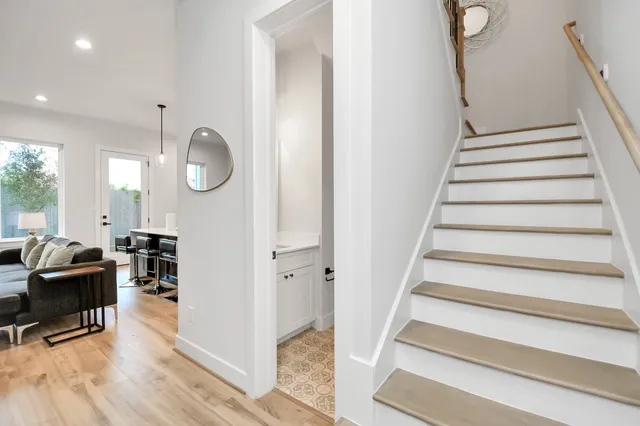 a view of entryway and hall with wooden floor