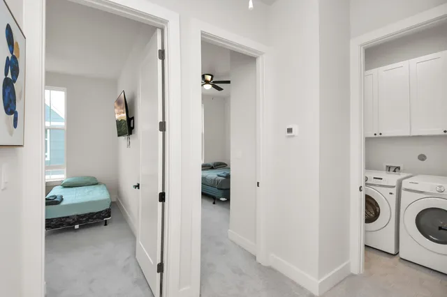 a view of a hallway with washer and dryer
