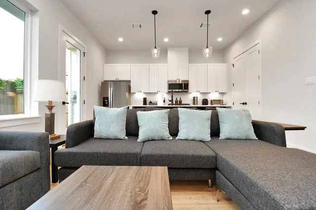 a living room with a couch and cabinets