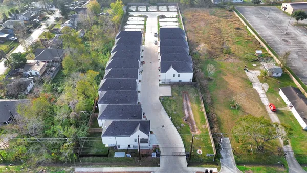 an aerial view of residential houses with outdoor space