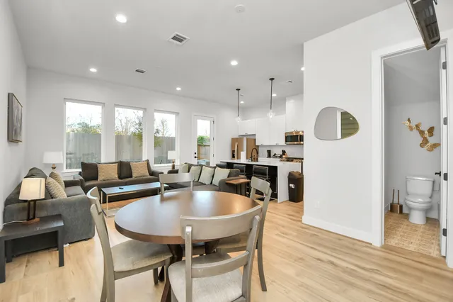 a dining room with kitchen island furniture a chandelier and kitchen view