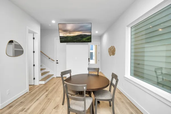 a view of a dining room with furniture and wooden floor