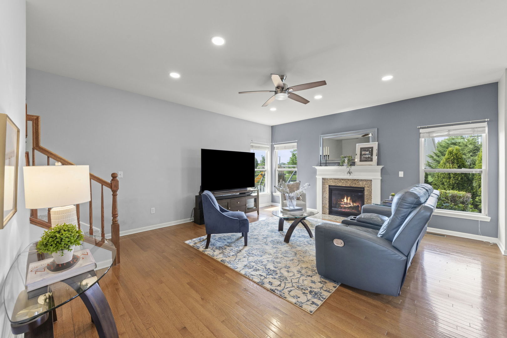 40W210 Palmer Road Geneva, IL 60134 - Photo 5 of 28 a living room with furniture a fireplace and a flat screen tv