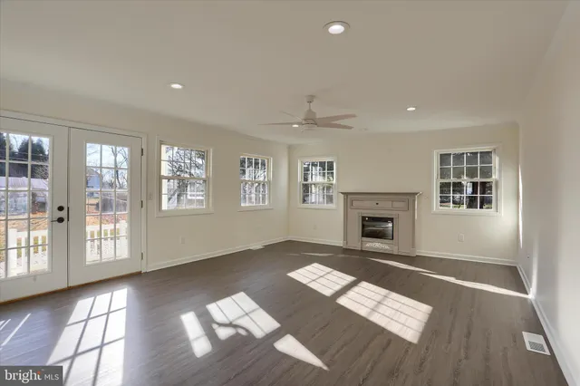 a view of an empty room with window and fire place