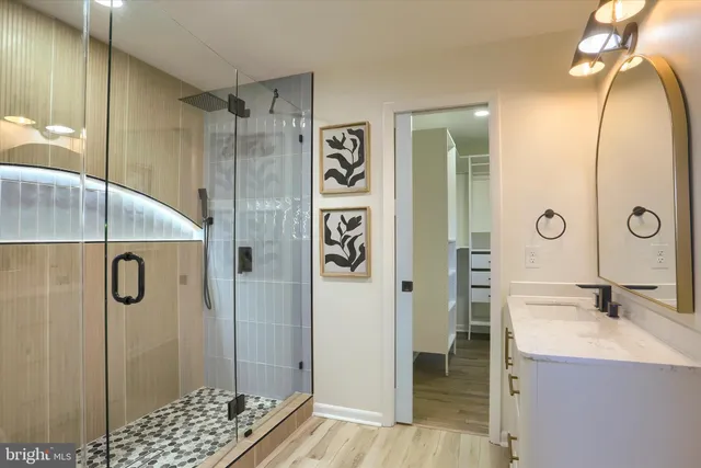 a bathroom with a shower sink and mirror