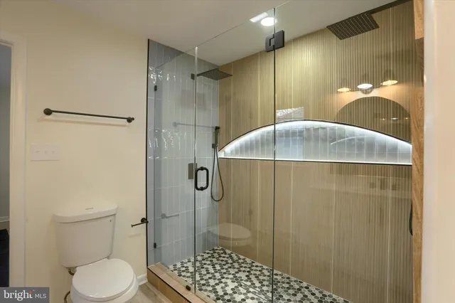 a bathroom with a shower toilet and sink