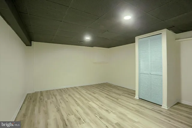 an empty room with wooden floor