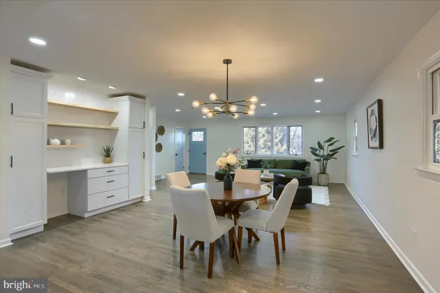 a view of a dining room with furniture and chandelier