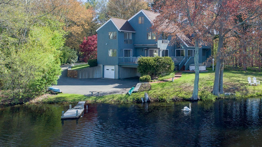 a view of a house with pool yard and lake view