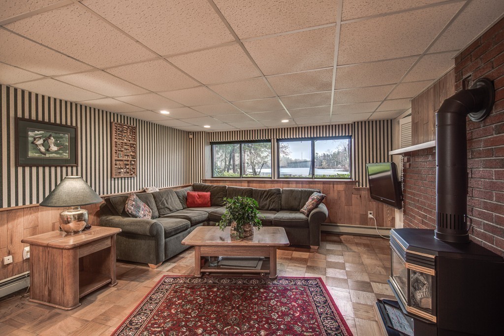 9 Beaver Pond Road Beverly, MA 01915 - Photo 15 of 21 a living room with furniture a flat screen tv and a window