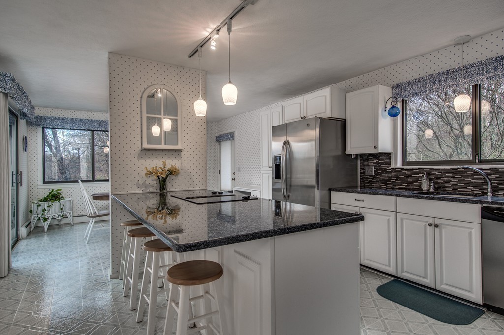 9 Beaver Pond Road Beverly, MA 01915 - Photo 5 of 21 a kitchen with stainless steel appliances granite countertop a sink a stove and a refrigerator
