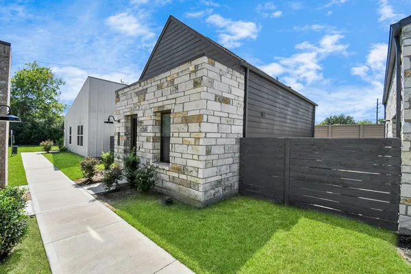 a backyard of a house with table and chairs