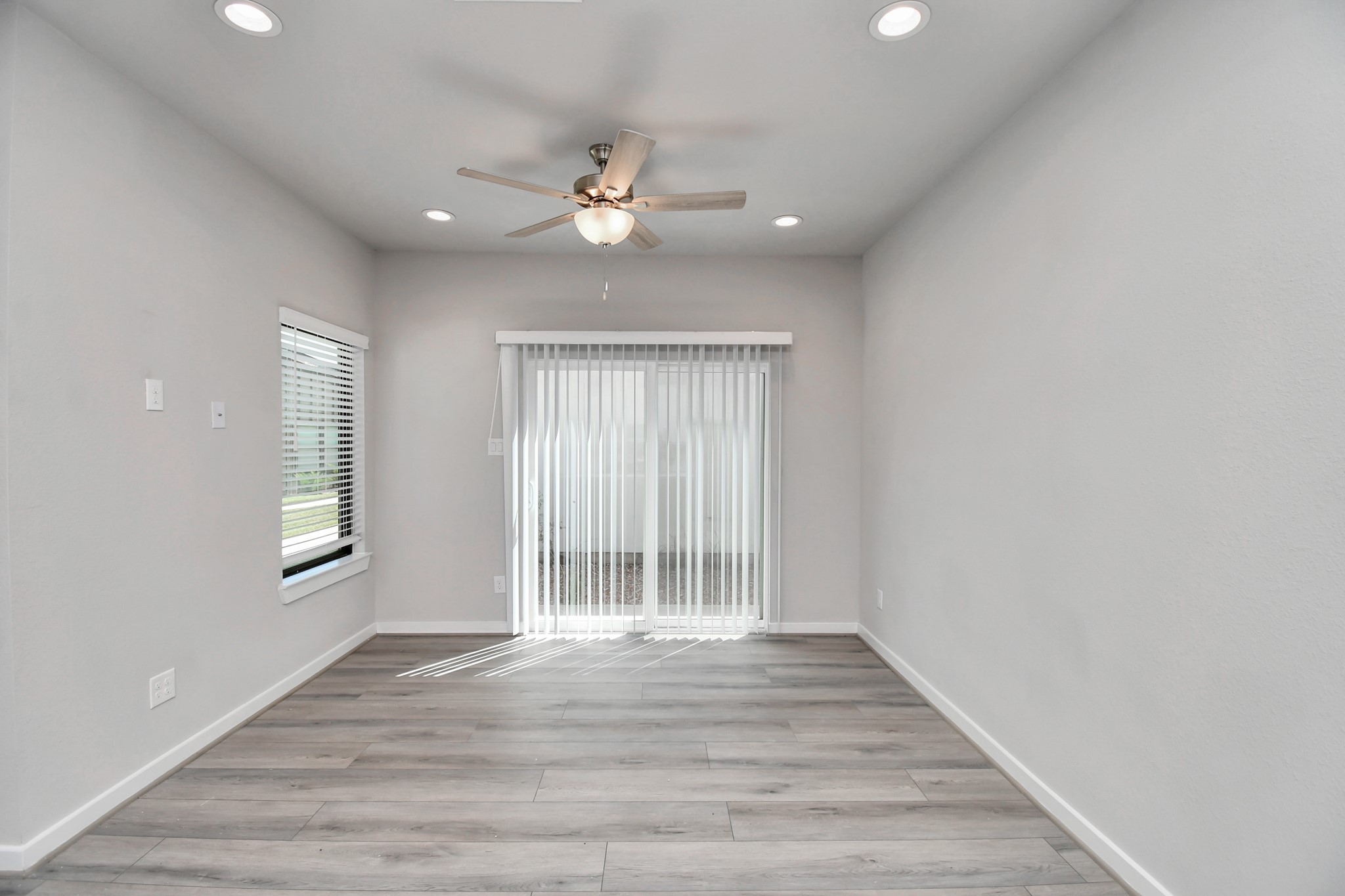 23823 Cumberland Ridge Drive, Unit 621 Hockley, TX 77447 - Photo 10 of 29 a view of an empty room with wooden floor and a window